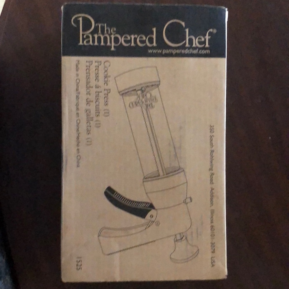 Never opened, The Pampered Chef cookie press.